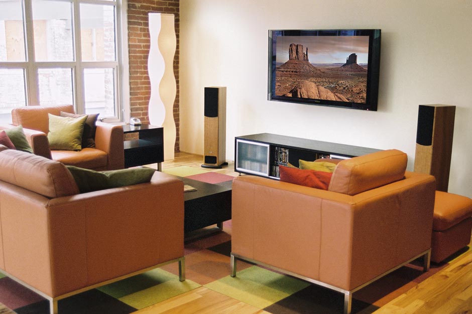RESIDENTIAL Interior - Home theater installation in a downtown loft. Removed unwanted wall shadows behind speakers. Retouched screen overlay, added glass reflections on plasma screen.